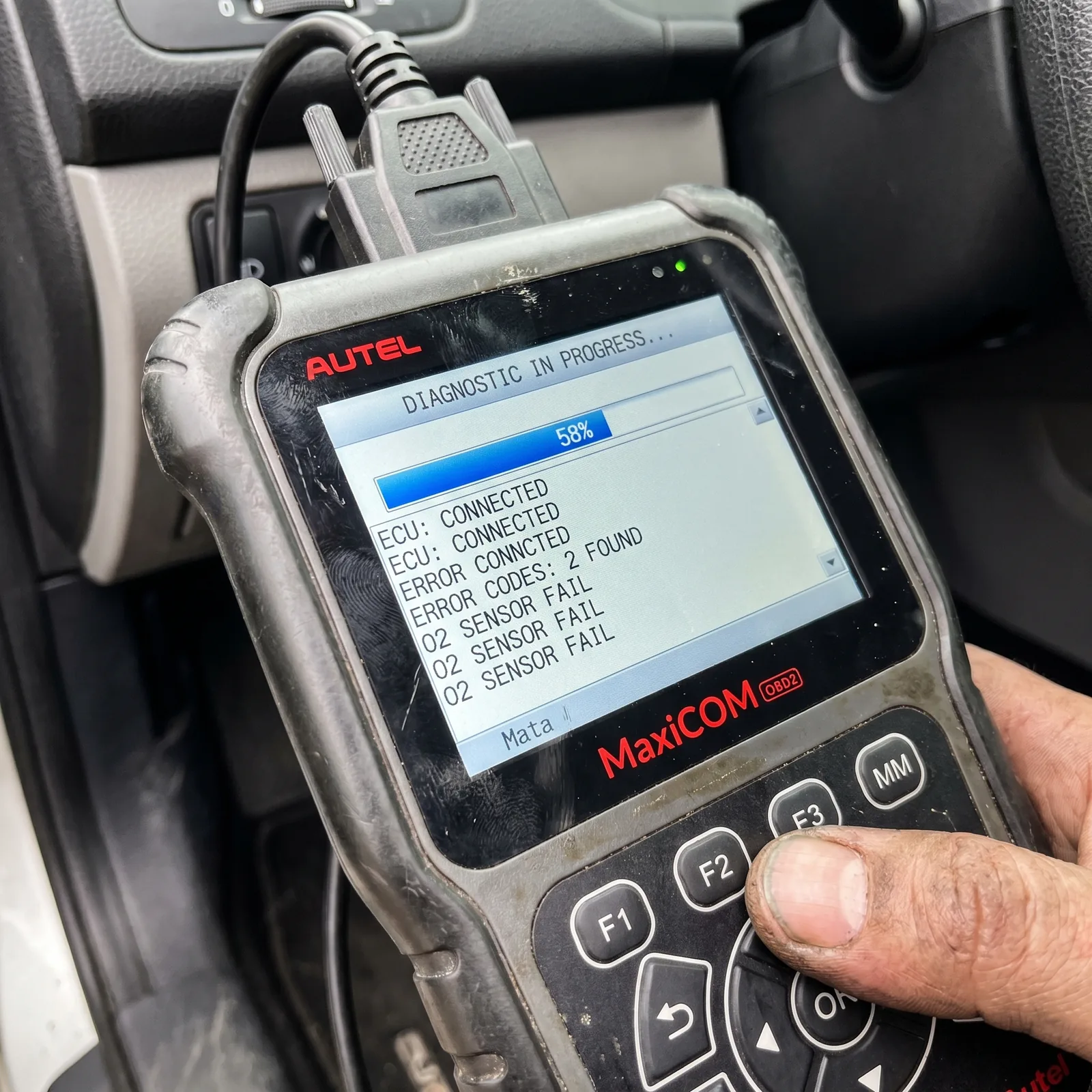 Mechanic running diagnostics on a vehicle
